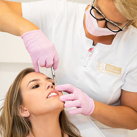 Lip injections being given by an aesthetics practitioner