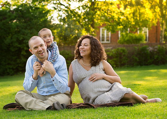Family with young son and pregnant mother relax and have fun on the Long Walk in Windsor