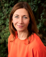 A natural light outdoor headshot of a professional woman