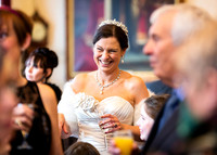 Bride captured candidly smiling during her wedding reception in Windsor Guildhall