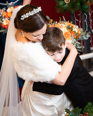 A bride embraces her son before he walks her down the aisle on her wedding day