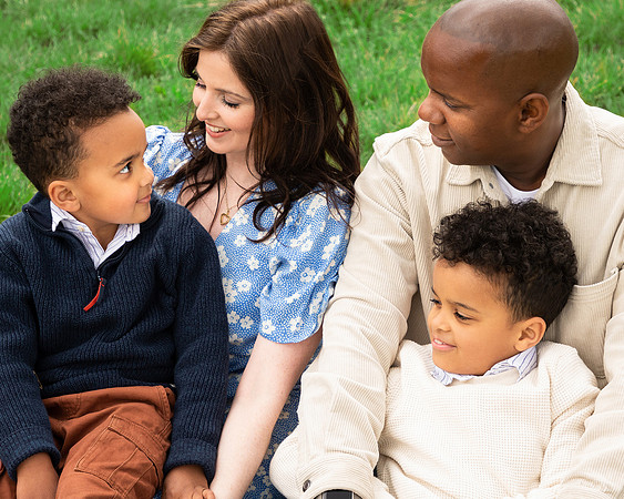 Close-up of a tender moment between parents and their two young sons