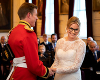 A bride and groom laugh during their ceremony in Windsor Guildhall's Grand Chamber