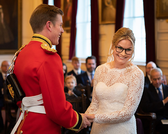 A bride and groom laugh during their ceremony in Windsor Guildhall's Grand Chamber