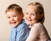 Boy & girl siblings smile (close-up)