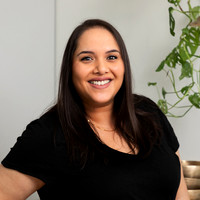 Natural on-location headshot of a woman smiling at the camera