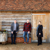Three business people standing outside waiting for a client