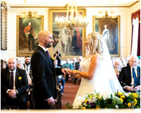 Bride & groom exchange rings curing their wedding ceremony within the Windsor Guildhall