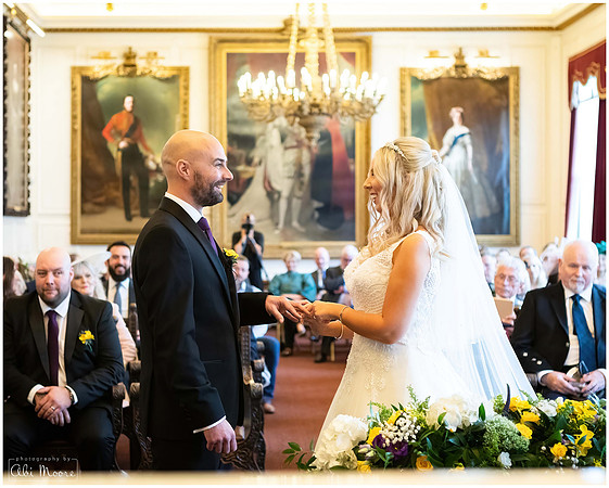 Bride & groom exchange rings curing their wedding ceremony within the Windsor Guildhall