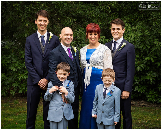 Bride and groom photographed with their sons in the grounds of Berystede Ascot