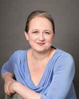 Relaxed professional headshot of a woman smiling at the camera