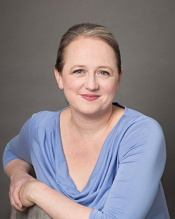 Relaxed professional headshot of a woman smiling at the camera