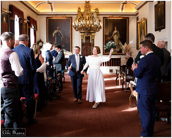 Bride & groom dance down the aisle together in Windsor Guildhall