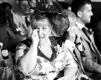 Mother-of-the-groom laughing through happy tears at her son’s wedding ceremony