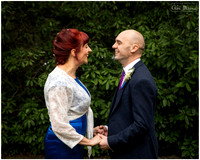 Bride and groom photographed smiling at each other at their wedding at Berystede Ascot