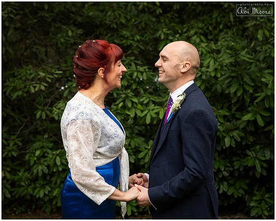 Bride and groom photographed smiling at each other at their wedding at Berystede Ascot